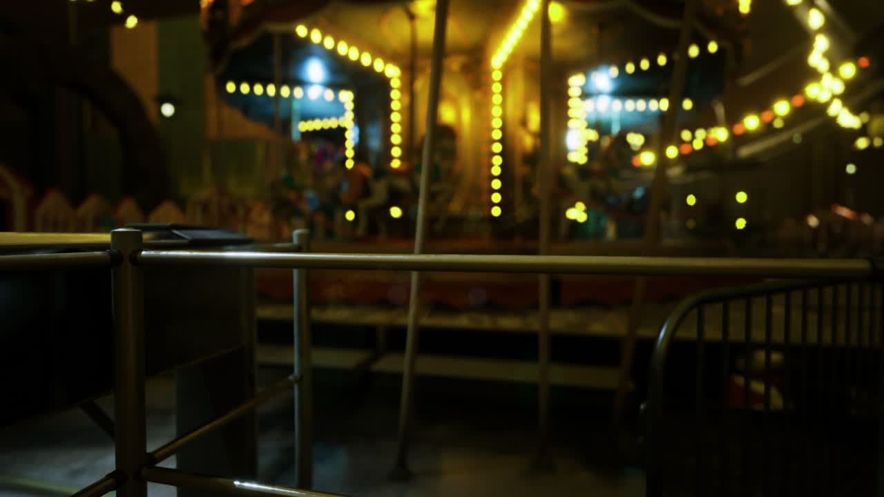 Evening at the amusement park with illuminated carousel and festive lights