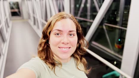 young woman walking through jet bridge to board flight