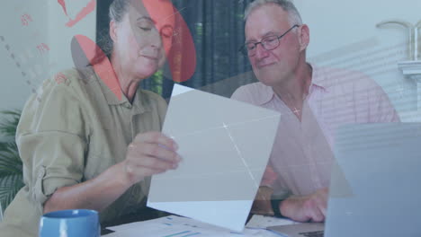 animation of financial data processing over senior caucasian couple using laptop