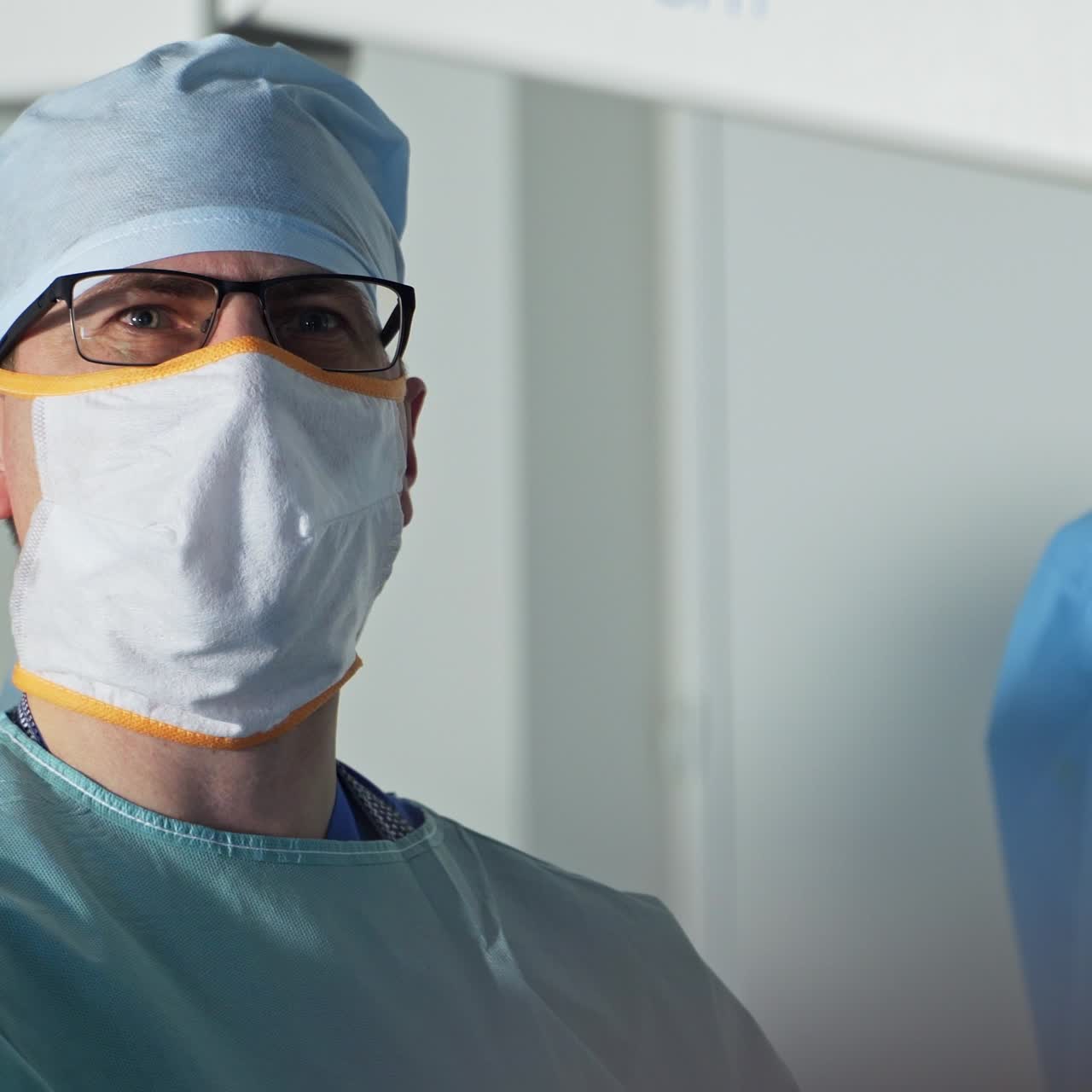 Team of experienced surgeons working together in operation room. Professional surgeons in sterile uniform