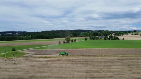 A-view-of-efficient-combined-harvesting-in-action-when-the-camera-from-the-drone-captures-the-side-of-the-combine-in-motion-and-zooms-out-at-the-same-time