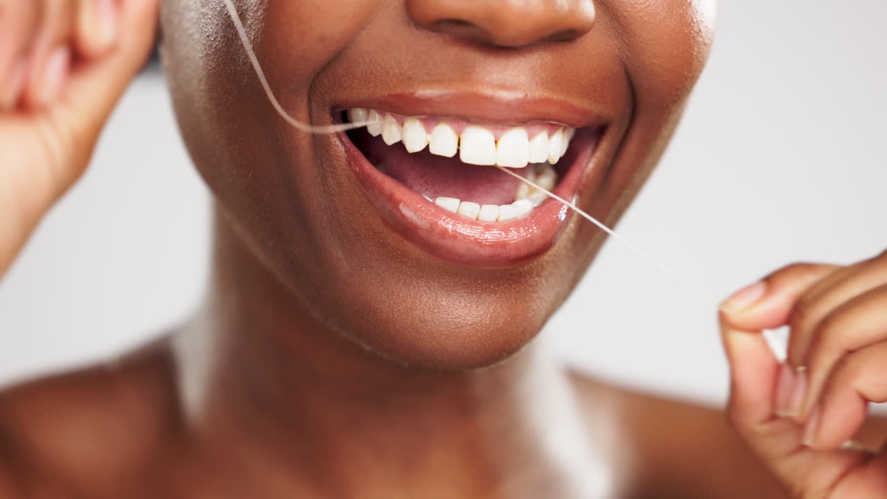 Face, hands and black woman flossing teeth