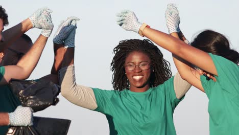 Volunteers-giving-high-five-in-park