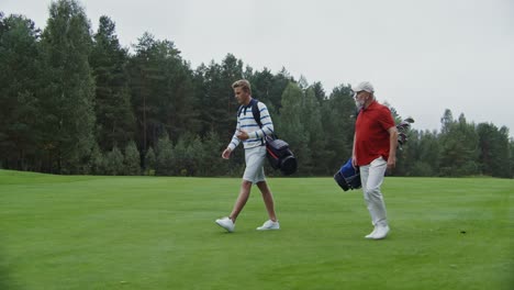 father and son playing golf