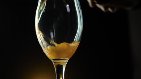 craft beer being poured into a glass in slow motion