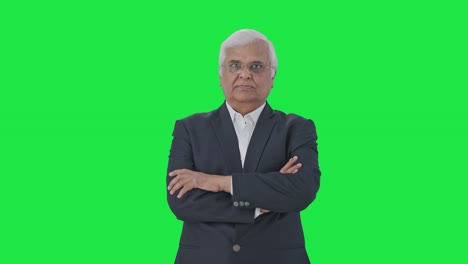 Indian-senior-journalist-standing-crossed-hands-Green-screen