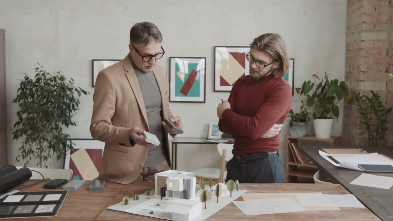 Male Architects Choosing Building Material For New House