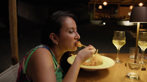woman eating shrimps skewer for dinner at the beach resort