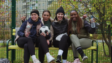 women sitting on a bench after sports