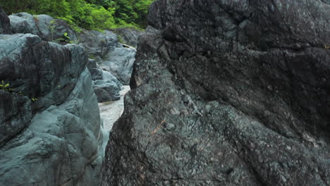 rock formations and tropical vegetation around nizao river in dominican republic - drone ascending