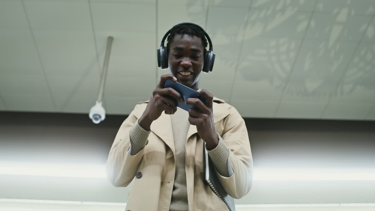 Man playing video game on smartphone