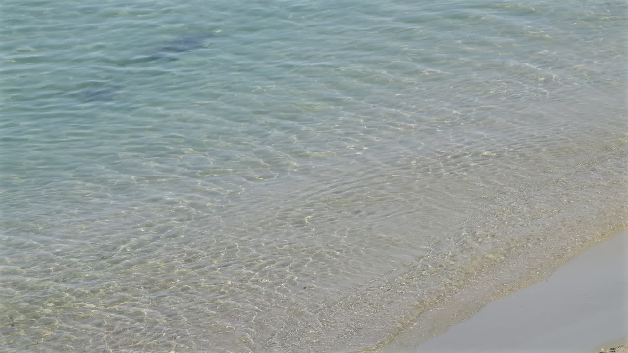 Close up of the clear, blue water of the Mediterranean sea on the shore