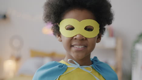 happy child in superhero costume