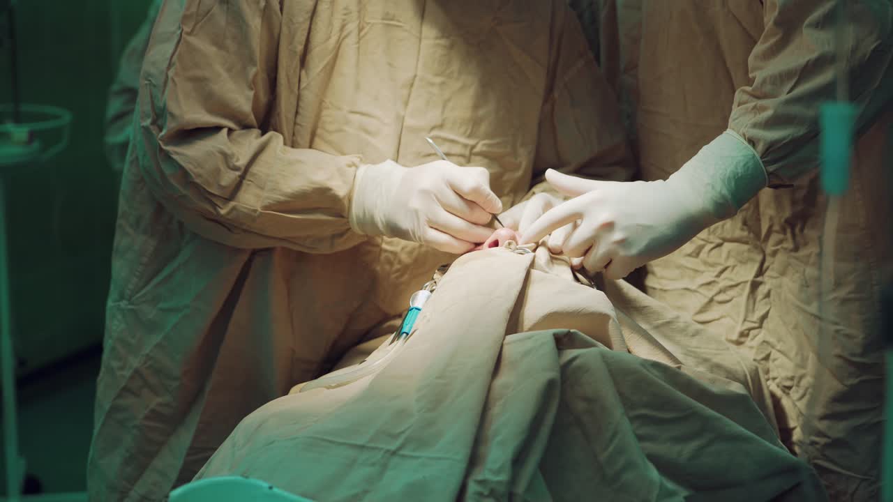 Surgeons being busy in the emergency room, performing surgery. Working with surgical instruments