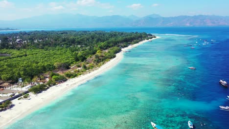 flying over white sand beach tropical sea green forest turquoise water coral reef