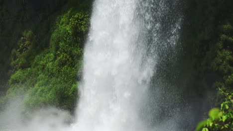 Iguazu-Falls-Waterfall-in-Argentina,-Panning-Slow-Motion-View-of-Large-Crashing-Waterfall-into-Huge-Plunge-Pool,-Water-Falling-in-Beautiful-Rainforest-Sunny-Weather-in-South-America