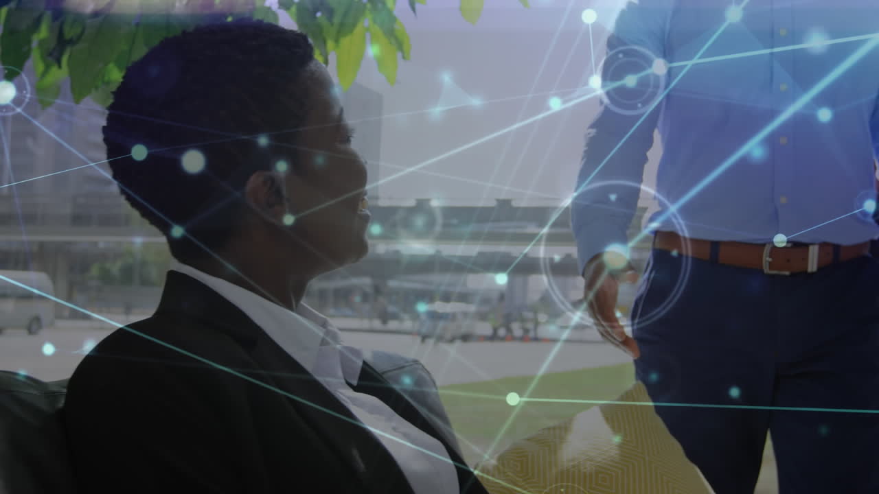 Animation of networks of connections over diverse business people shaking hands in office