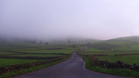 Road-trip-in-Terceira-Island,-Azores-surrounded-by-green-landscape-on-a-very-foggy-day