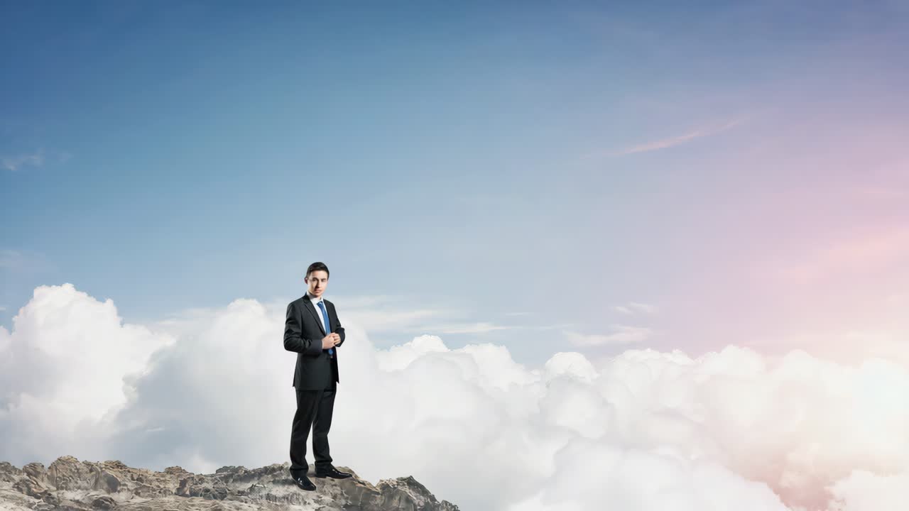 A businessman standing on a mountain top