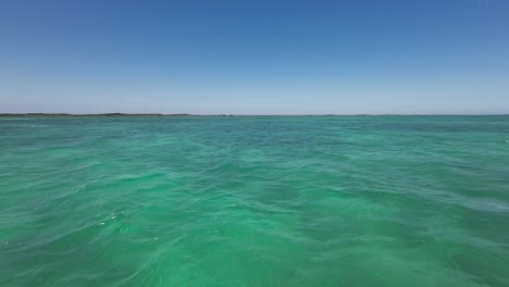 Aerial-dolly-above-mystical-green-tropical-Caribbean-water-of-Los-Roques-Venezuela