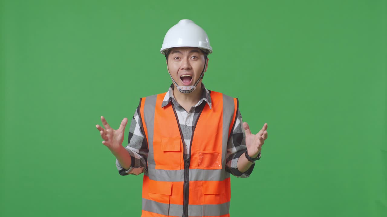 Asian Male Engineer With Safety Helmet Smiling To Camera And Saying Wow While Standing In The Green Screen Background Studio