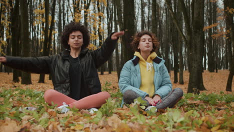 Two women meditating outdoors