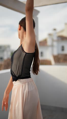 teenage ballerina posing on rooftop