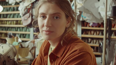 portrait of young caucasian woman in workshop