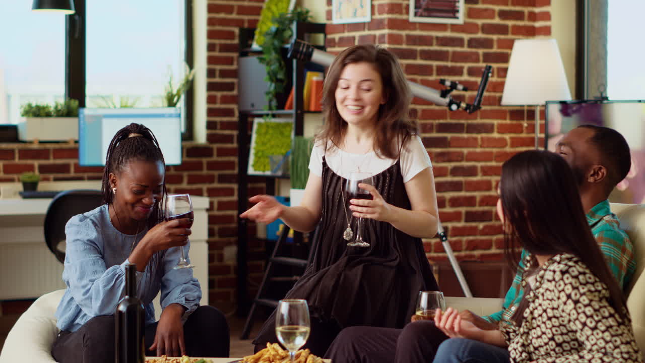 Woman entertaining friends at house party, sharing with them interesting story