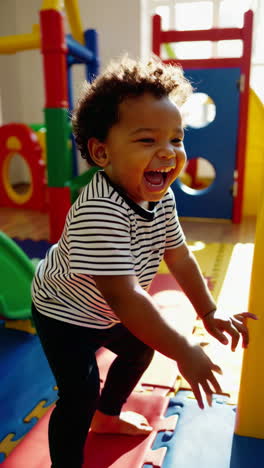 a joyful child laughing and playing in a colorful indoor playground