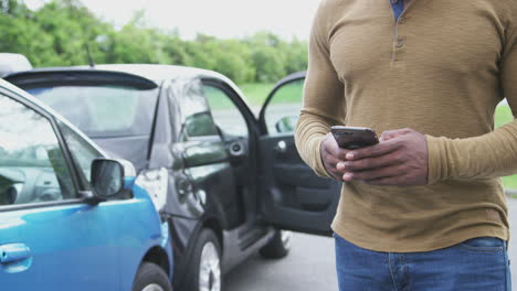 Drivers-Involved-In-Car-Accident-Taking-Pictures-Of-Damage-And-Contacting-Insurance-Company