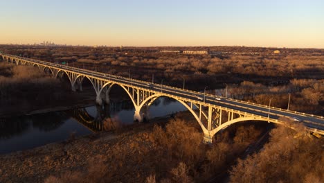 Dramatic-aerial-view-of-Mendota-Bridge-and-surrounding-area,-during-golden-hour