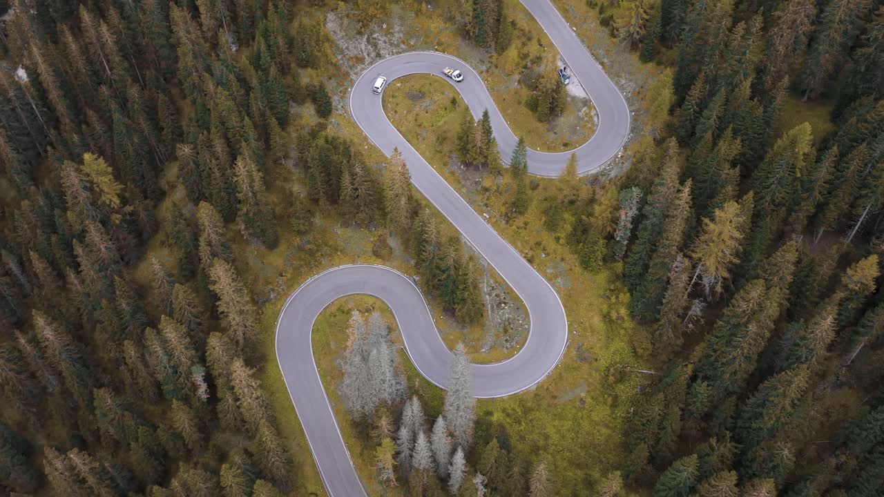 4K Aerial cinematic shot of the Dolomites’ famous Snake Road with vibrant fall colours. Italy_03