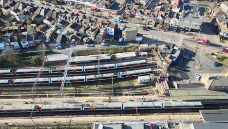 chingford overground station train leaves ,east london uk aerial footage