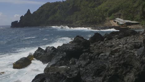 muelle de la isla pitcairn con olas rompiendo en las rocas de la orilla