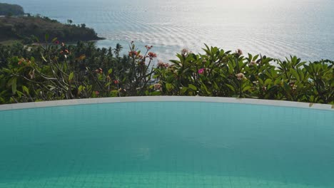 golden hour with reflections of the ocean seen from the hotels infinity pool