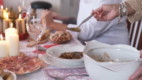 slow motion video of woman serving food at the table at christmas