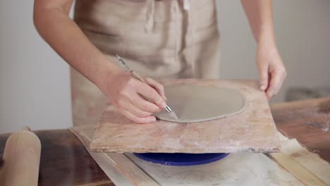 woman creating pottery on a pottery wheel