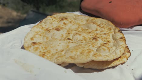 self baked traditional afghan bread from tandoor in moria refugee camp