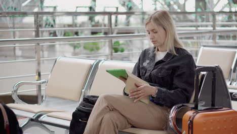 woman using tablet in airport waiting area