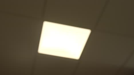 modern led panel shining bright on ceiling, defocus closeup shot