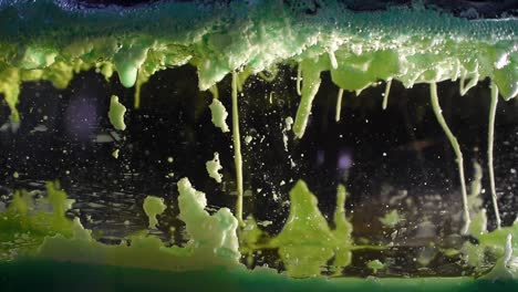 mirror surface with liquid oil bubbles rising and falling in a depth view alien landscape