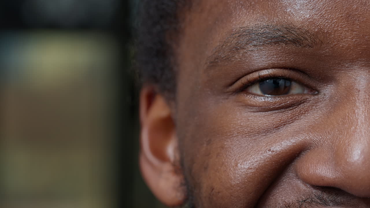 Macro shot of man showing half of face and one eye