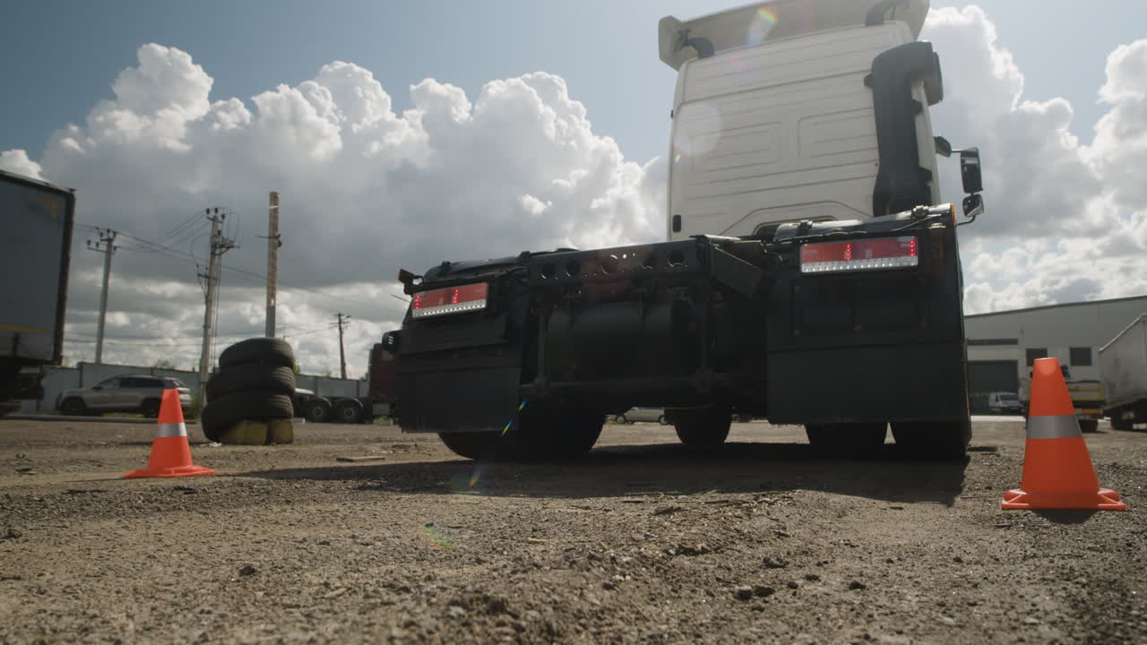 Truck and trailer in a lot with cloudy sky
