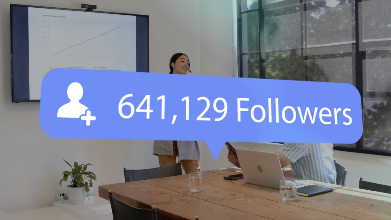 Donna che indica un grafico che mostra la crescita dei follower, oscurando il team e indicando la crescita del marketing