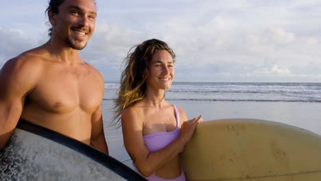 Young-couple-with-surfboards