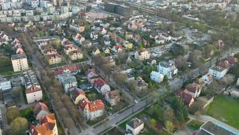 Aerial-view-of-a-cozy-residential-area-with-diverse-housing-and-tree-lined-streets,-during-the-golden-hour