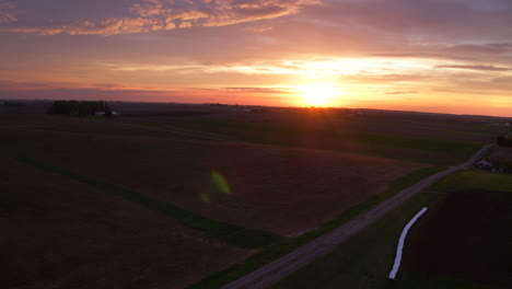 slow descent over a lonely old country road at sunset in the midwest