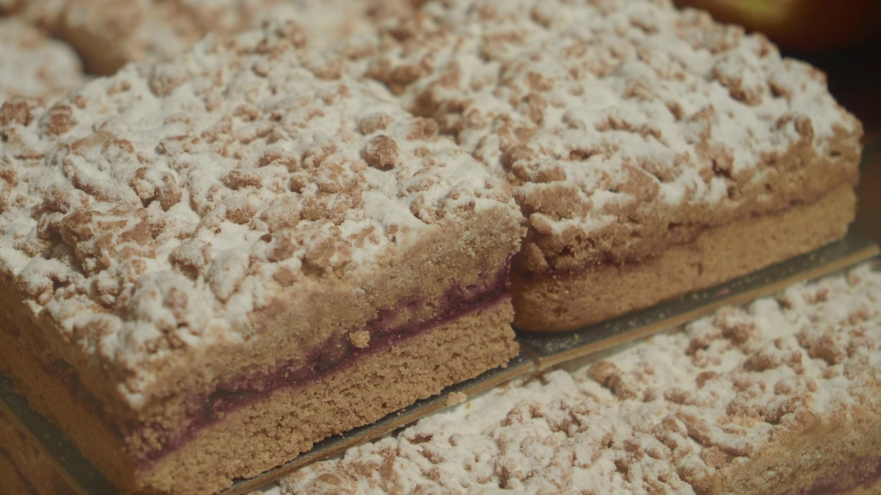 Appetizing Crumb Cake Slices with Powdered Sugar and Jam Filling