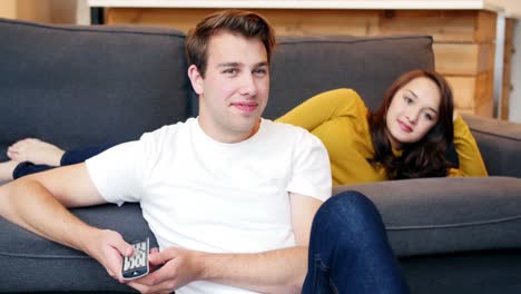 couple embracing on sofa in living room